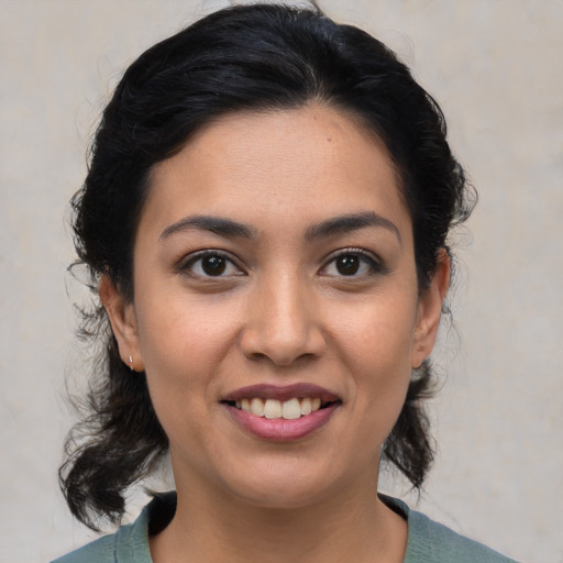 Joyful white young-adult female with medium  black hair and brown eyes