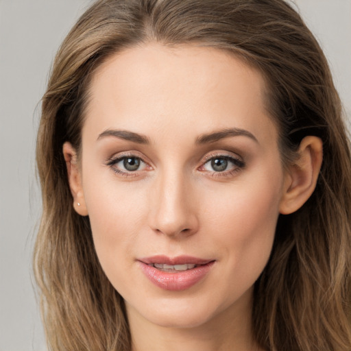 Joyful white young-adult female with long  brown hair and grey eyes