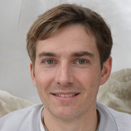 Joyful white adult male with short  brown hair and grey eyes