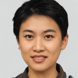 Joyful asian young-adult female with short  black hair and brown eyes