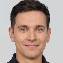 Joyful white adult male with short  brown hair and brown eyes