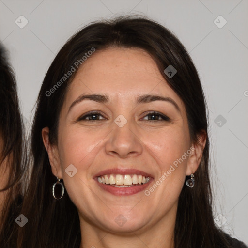 Joyful white adult female with long  brown hair and brown eyes