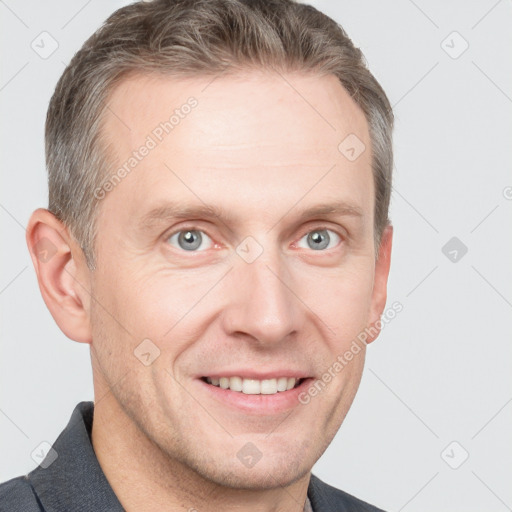 Joyful white adult male with short  brown hair and grey eyes