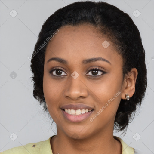 Joyful black young-adult female with short  black hair and brown eyes