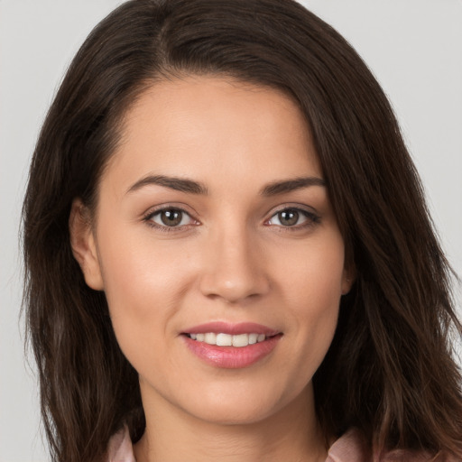 Joyful white young-adult female with long  brown hair and brown eyes