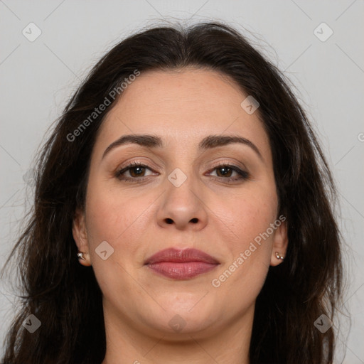 Joyful white adult female with long  brown hair and brown eyes