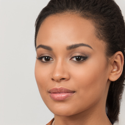 Joyful latino young-adult female with long  brown hair and brown eyes