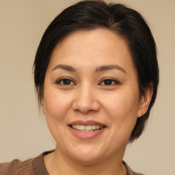 Joyful white adult female with medium  brown hair and brown eyes