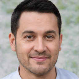 Joyful white adult male with short  brown hair and brown eyes