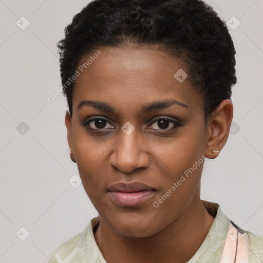 Joyful black young-adult female with short  black hair and brown eyes