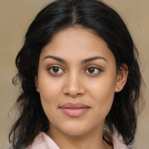 Joyful latino young-adult female with long  brown hair and brown eyes
