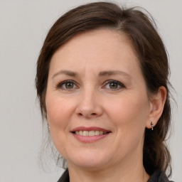 Joyful white adult female with medium  brown hair and grey eyes