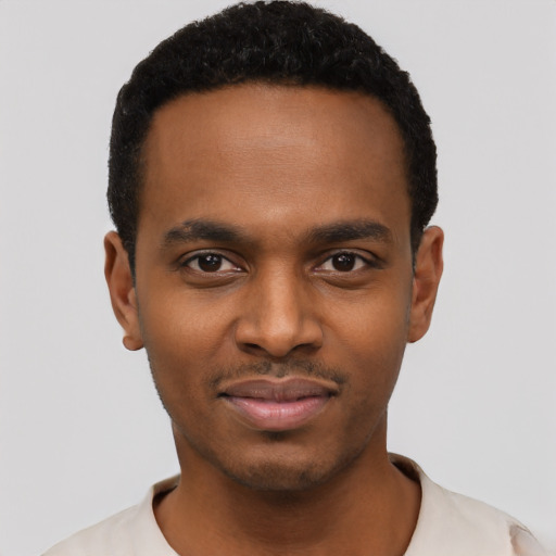 Joyful black young-adult male with short  black hair and brown eyes