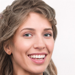 Joyful white young-adult female with long  brown hair and green eyes