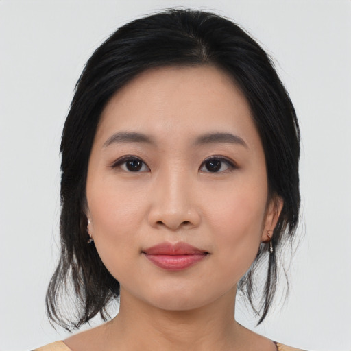 Joyful asian young-adult female with medium  black hair and brown eyes