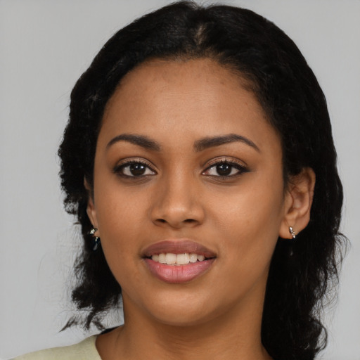 Joyful latino young-adult female with long  black hair and brown eyes
