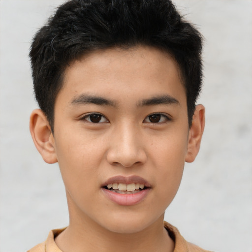 Joyful asian young-adult male with short  brown hair and brown eyes