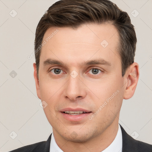 Joyful white young-adult male with short  brown hair and brown eyes