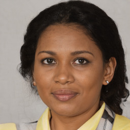 Joyful black adult female with short  brown hair and brown eyes