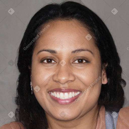 Joyful black adult female with long  brown hair and brown eyes