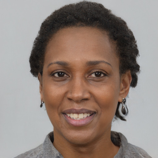 Joyful black adult female with short  brown hair and brown eyes
