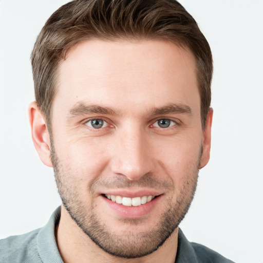 Joyful white young-adult male with short  brown hair and grey eyes