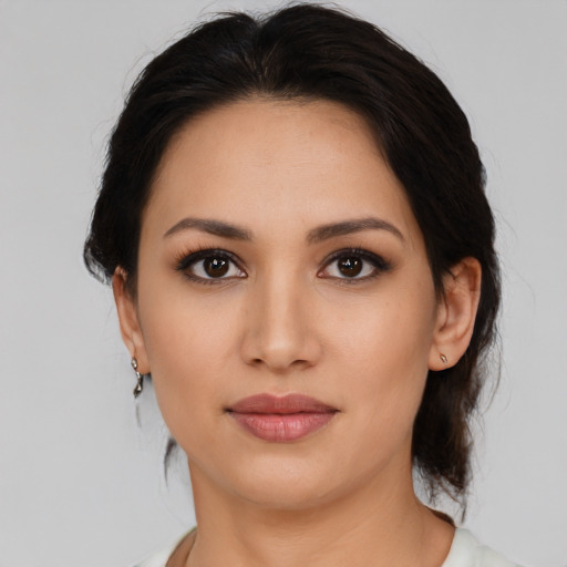 Joyful latino young-adult female with medium  brown hair and brown eyes