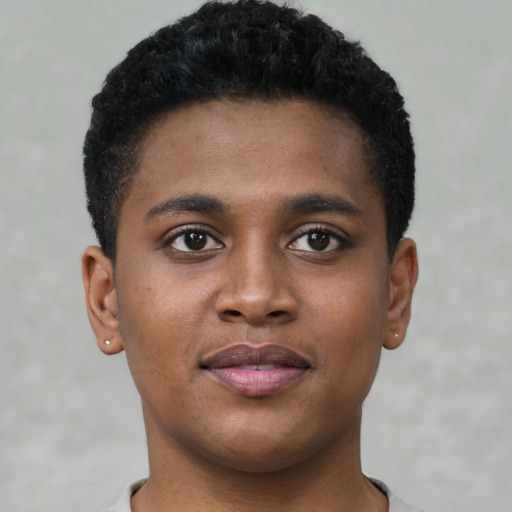 Joyful black young-adult male with short  brown hair and brown eyes