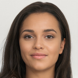 Joyful latino young-adult female with long  brown hair and brown eyes