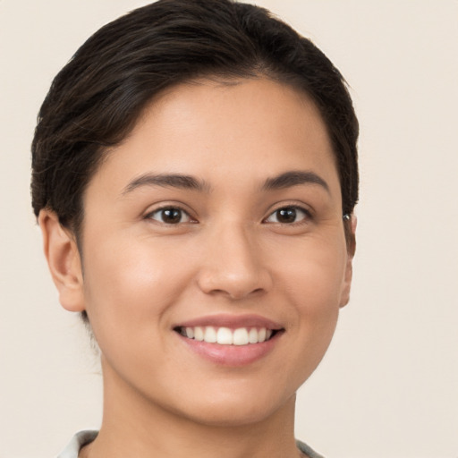 Joyful white young-adult female with short  brown hair and brown eyes