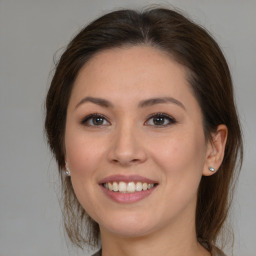 Joyful white young-adult female with medium  brown hair and brown eyes