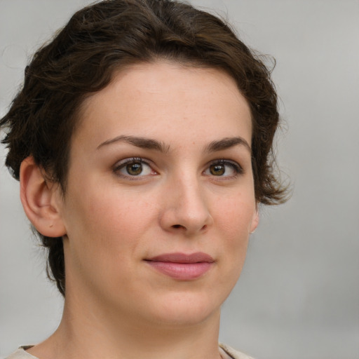 Joyful white young-adult female with short  brown hair and green eyes