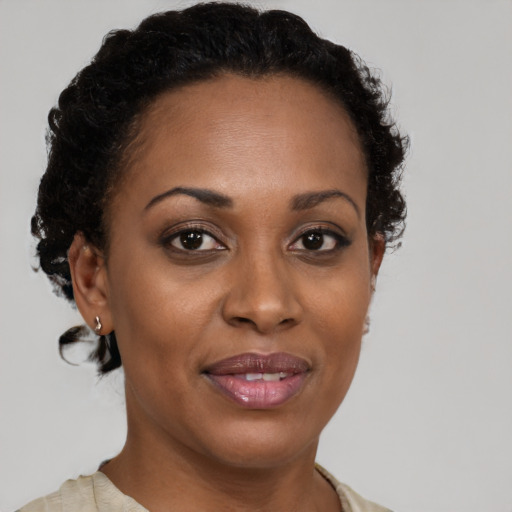 Joyful black adult female with short  brown hair and brown eyes