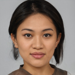 Joyful asian young-adult female with medium  brown hair and brown eyes