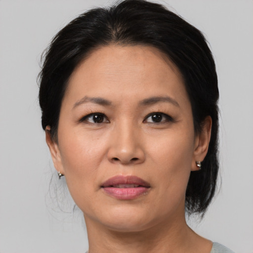 Joyful asian adult female with medium  brown hair and brown eyes