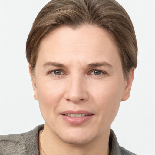 Joyful white adult female with short  brown hair and grey eyes