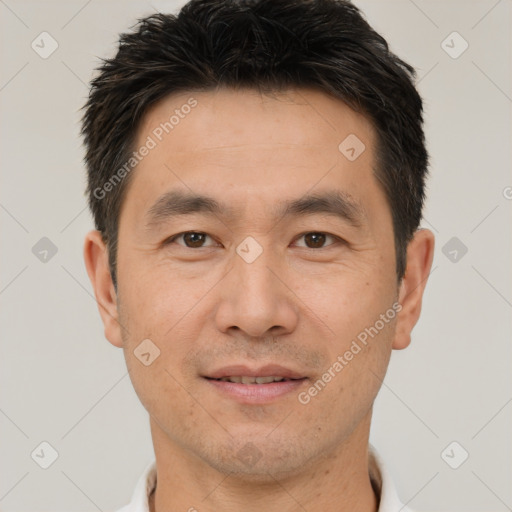 Joyful white adult male with short  brown hair and brown eyes