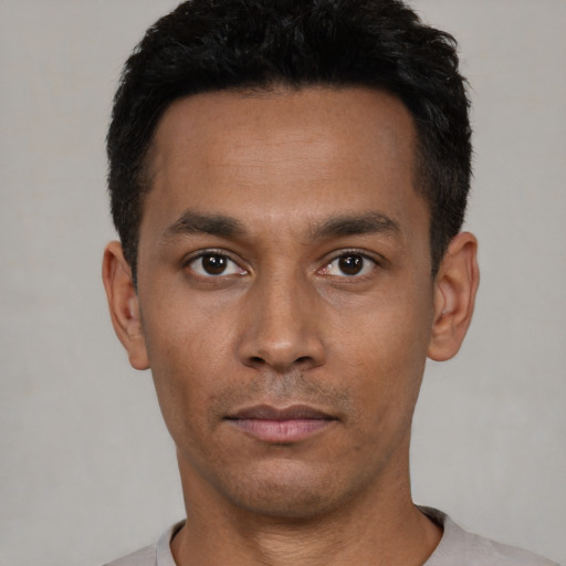 Neutral latino young-adult male with short  black hair and brown eyes