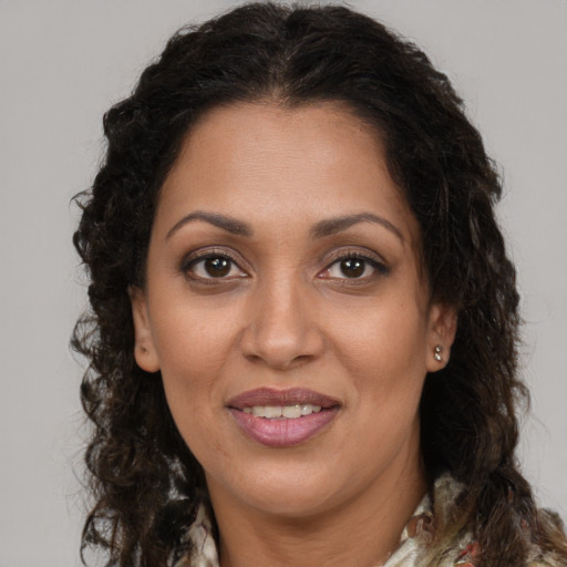 Joyful latino adult female with long  brown hair and brown eyes