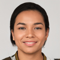 Joyful latino young-adult female with short  black hair and brown eyes