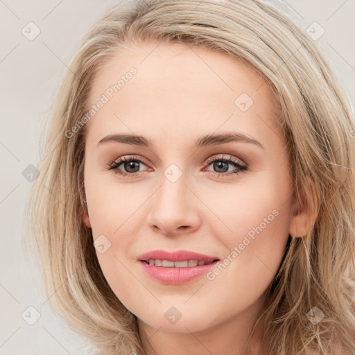 Joyful white young-adult female with long  brown hair and blue eyes