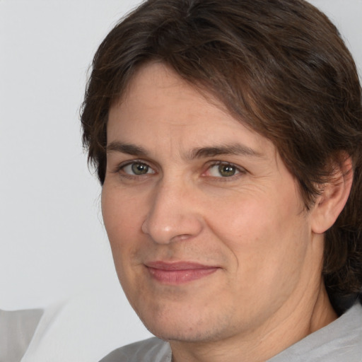 Joyful white adult male with medium  brown hair and brown eyes