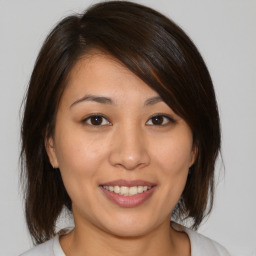 Joyful white young-adult female with medium  brown hair and brown eyes