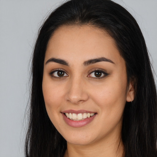 Joyful white young-adult female with long  brown hair and brown eyes