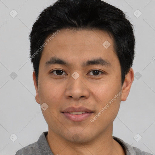 Joyful asian young-adult male with short  black hair and brown eyes