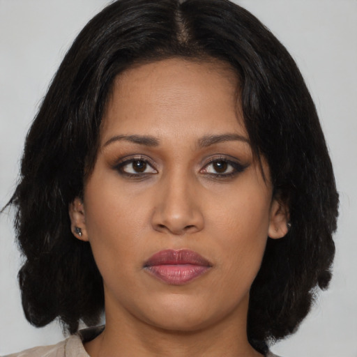 Joyful asian young-adult female with medium  brown hair and brown eyes