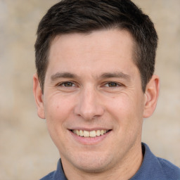 Joyful white adult male with short  brown hair and brown eyes