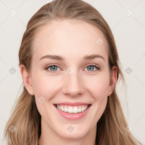 Joyful white young-adult female with long  brown hair and blue eyes