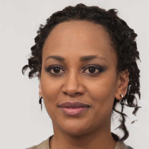Joyful black young-adult female with medium  brown hair and brown eyes