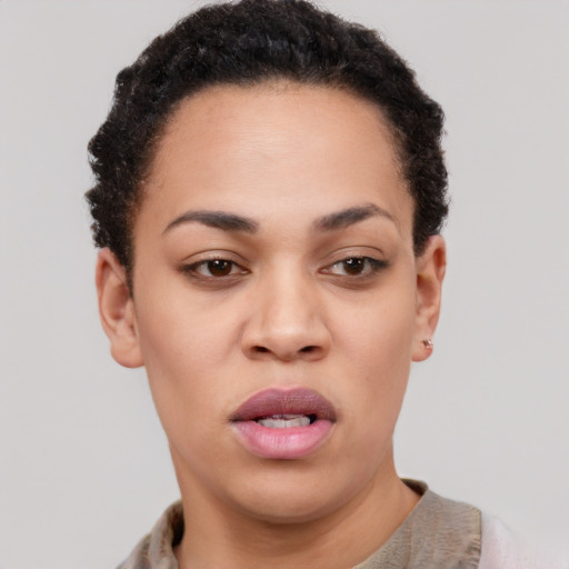 Joyful latino young-adult female with short  black hair and brown eyes